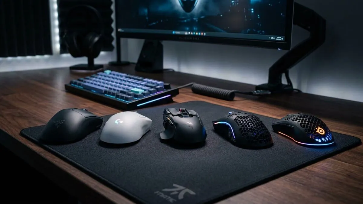 multiple gaming mice comparison on gaming setup desk with keyboard and monitor